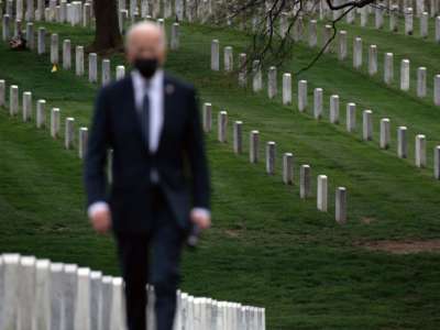 President Joseph Robinette Biden walks away from the corpses of the fallen