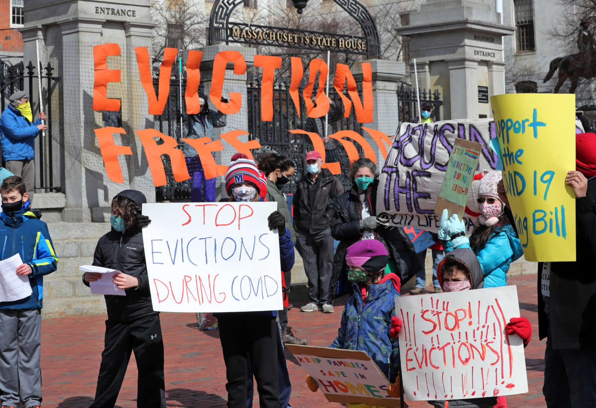 People and students from Worker's Circle of Boston and members of City Life Vida Urbana protest to rally support behind House Bill 3030, which seeks to stop evictions during the ongoing coronavirus pandemic, at the Massachusetts State House in Boston on March 14, 2021.