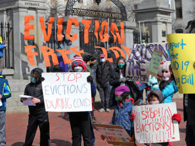 People and students from Worker's Circle of Boston and members of City Life Vida Urbana protest to rally support behind House Bill 3030, which seeks to stop evictions during the ongoing coronavirus pandemic, at the Massachusetts State House in Boston on March 14, 2021.