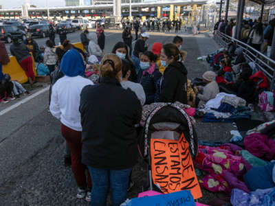 Migrants and asylum seekers are seen after spending the night in one of the car lanes off the San Ysidro Crossing Port on the Mexican side of the U.S./Mexico border in Tijuana, Baja California state, Mexico on April 24, 2021.