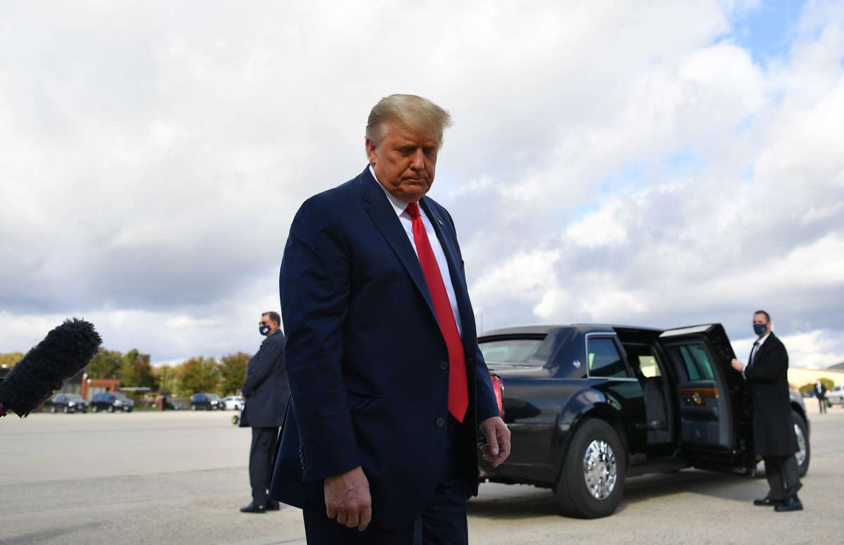 Trump stares at the ground, disappointed and orange