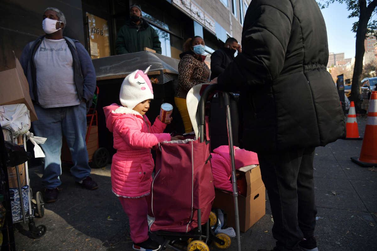 A view of a child as she stands in line with her family as Food Bank for New York City distributes turkeys and Thanksgiving fixings on November 16, 2020, in New York City.