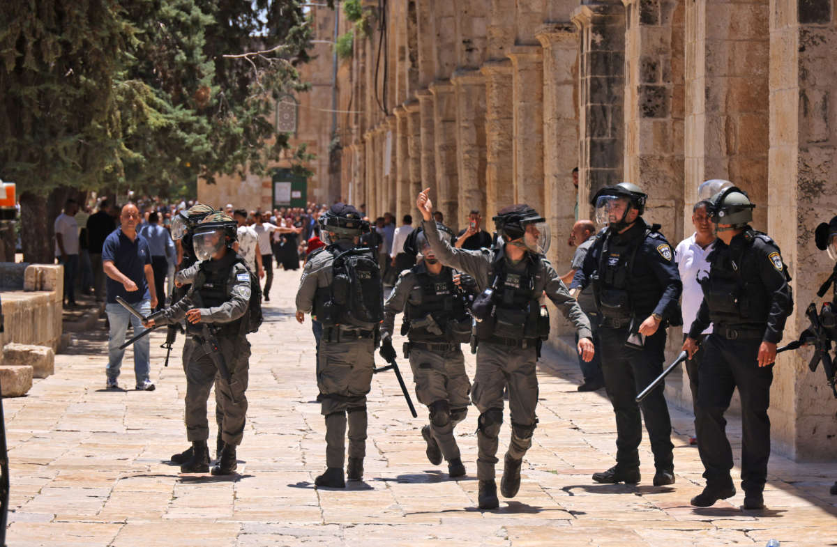 Israeli security forces walk in Jerusalem's al-Aqsa mosque compound, the third holiest site of Islam, on May 14, 2021.