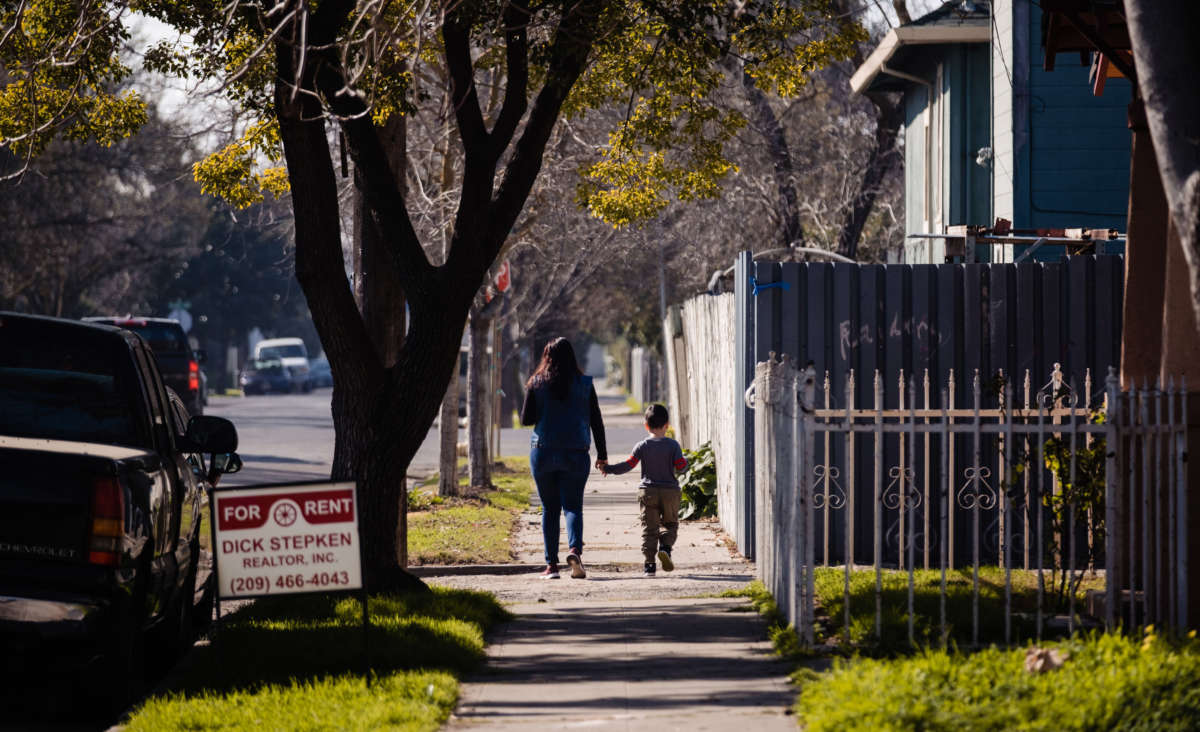 A mother and son walk through one of the neighborhoods of Stockton where participants in the city's universal basic income program live in Stockton, California, on February 7, 2020.