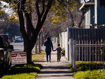 A mother and son walk through one of the neighborhoods of Stockton where participants in the city's universal basic income program live in Stockton, California, on February 7, 2020.