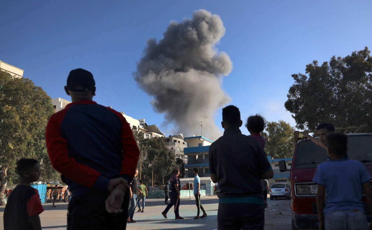 Palestinians, taking refuge at a UN school after fleeing their homes due to Israeli air and artillery strikes, gather in the school's courtyard after an Israeli strike on the Gaza Strip on May 14, 2021.