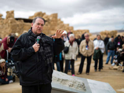 Former Arkansas Gov. Mike Huckabee is seen as he delivers a speech to a group of American Evangelical Christian tourists and pilgrims during a visit to the ancient hilltop fortress of Masada in the Judaean Desert in Israel, on February 19, 2015.