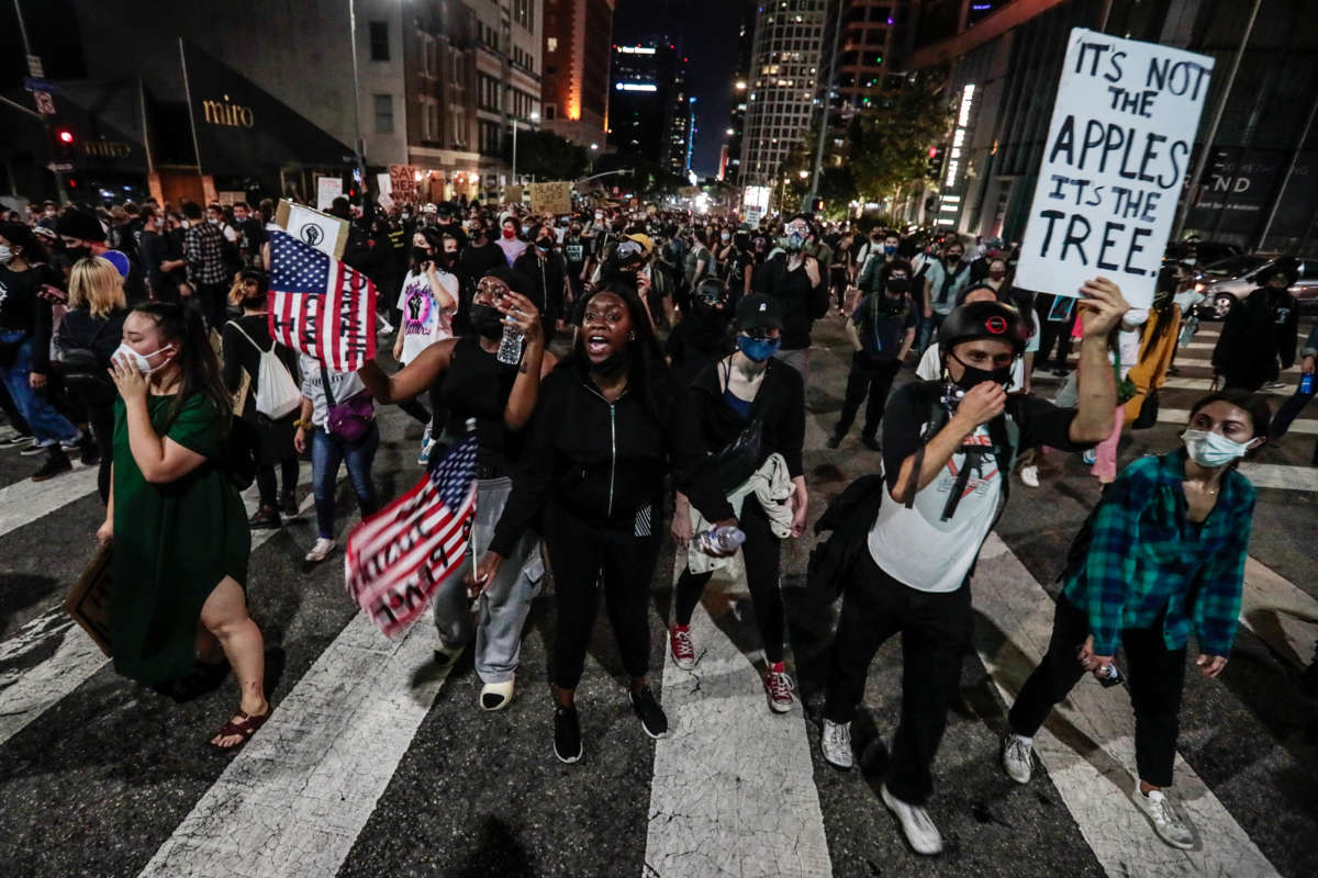 Hundreds march while protesting the grand jury decision to not charge the police officers who shot and killed Breonna Taylor, on September 23, 2020, in downtown Los Angeles, California.