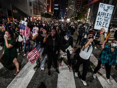 Hundreds march while protesting the grand jury decision to not charge the police officers who shot and killed Breonna Taylor, on September 23, 2020, in downtown Los Angeles, California.
