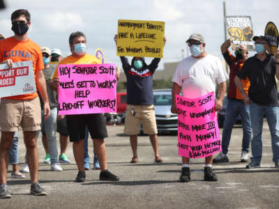 Protesters join together asking senators to support the continuation of unemployment benefits on July 16, 2020, in Miami Springs, Florida.