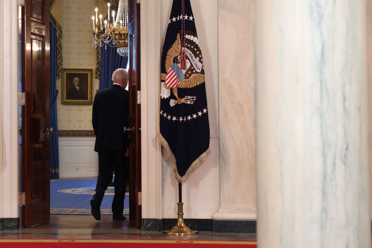 Joe Biden exits a room