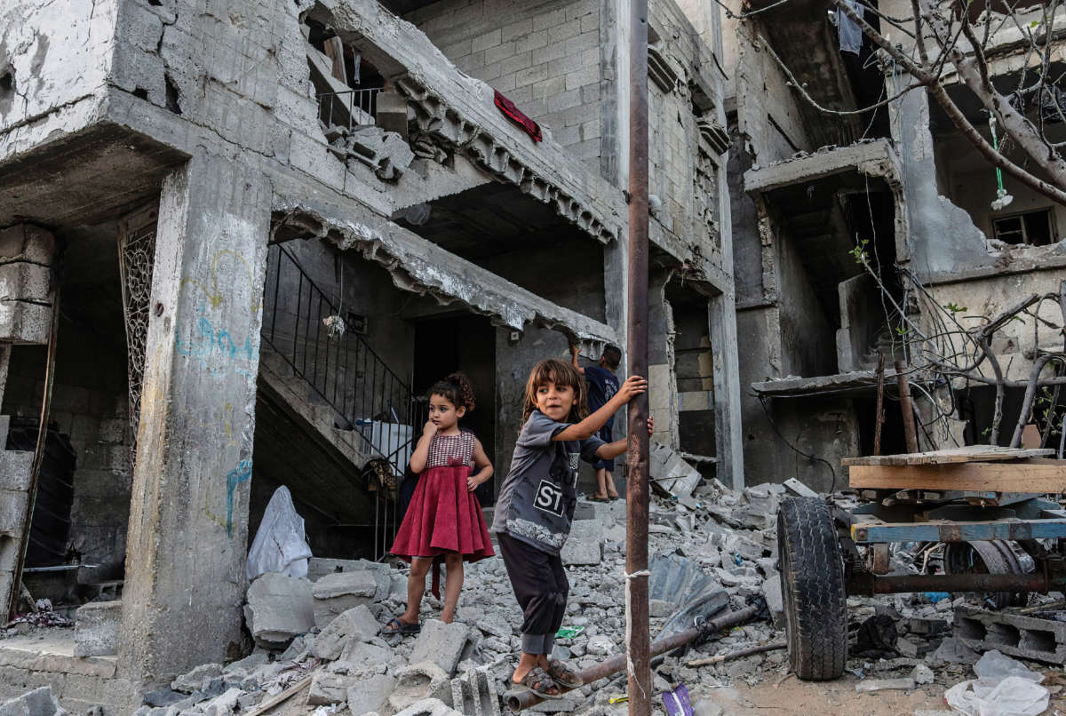 Palestinian children play in front of their destroyed homes in Beit Hanoun following the Israel airstrikes in Gaza on May 26, 2021.