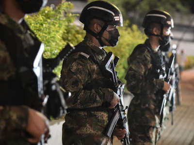 Soldiers stand on patrol outside the Coliseo de Hockey Miguel Calero a day after protests against the government of Colombian President Iván Duque on May 29, 2021 in Cali, Colombia.