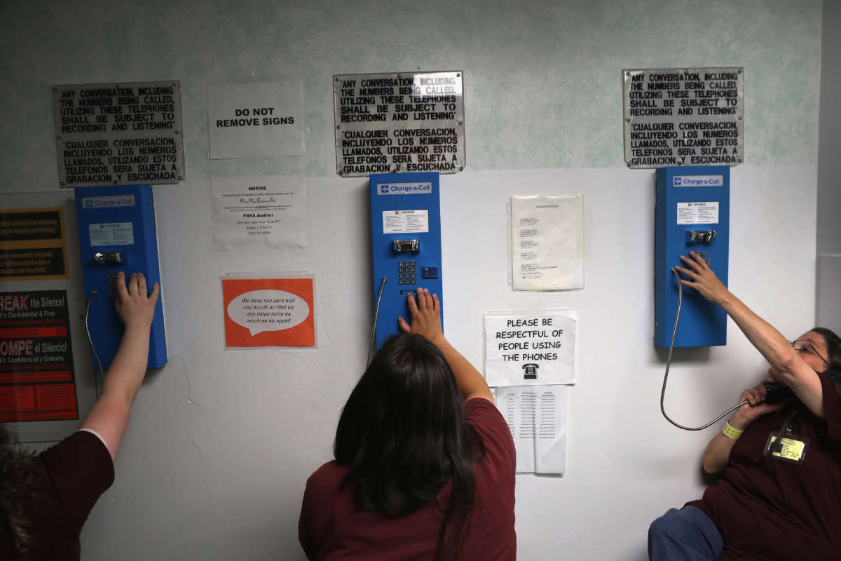 Incarcerated people make one of their daily allotment of six phone calls at the York Community Reintegration Center on May 24, 2016, in Niantic, Connecticut. In nearly all jails around the country, phone calls are recorded and surveilled.