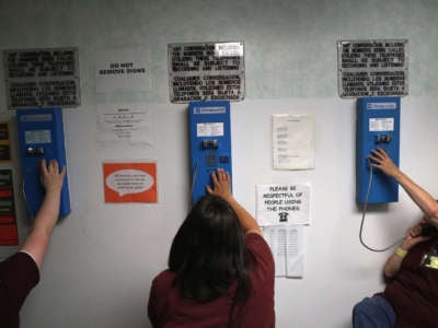 Incarcerated people make one of their daily allotment of six phone calls at the York Community Reintegration Center on May 24, 2016, in Niantic, Connecticut. In nearly all jails around the country, phone calls are recorded and surveilled.
