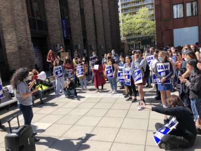 Members of the graduate workers union at New York University listen to a speaker on April 30, 2021.