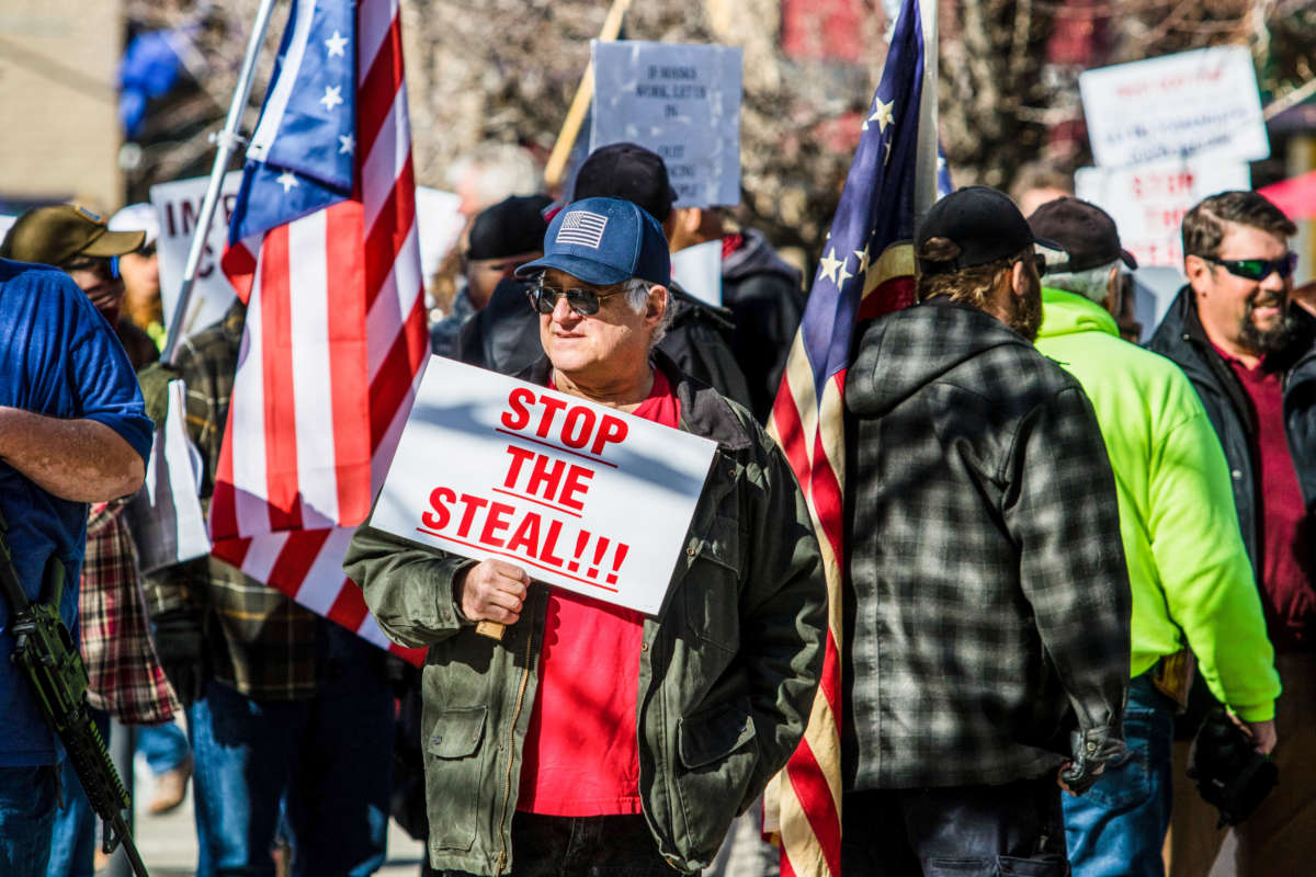 A protestor holds a sign reading "Stop the Steal" during a demonstration at the Nevada State Capitol on February 1, 2021, in Carson, Nevada.