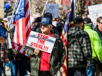 A protestor holds a sign reading "Stop the Steal" during a demonstration at the Nevada State Capitol on February 1, 2021, in Carson, Nevada.