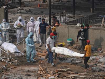 Bodies of victims who died due to the COVID-19 coronavirus are seen before cremation at a cremation ground in New Delhi, India, on May 2, 2021.