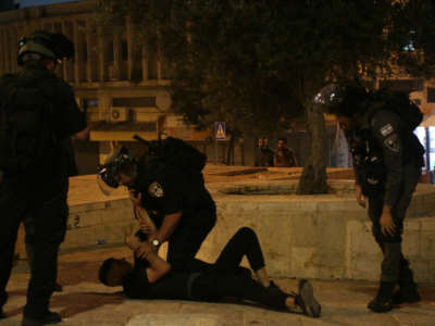 Israeli police arrest a Palestinian amid protests outside the Damascus Gate of Jerusalem on May 8, 2021.