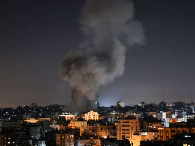 Smoke billows above buildings after an Israeli airstrike on Gaza City in the Gaza Strip early on May 15, 2021.