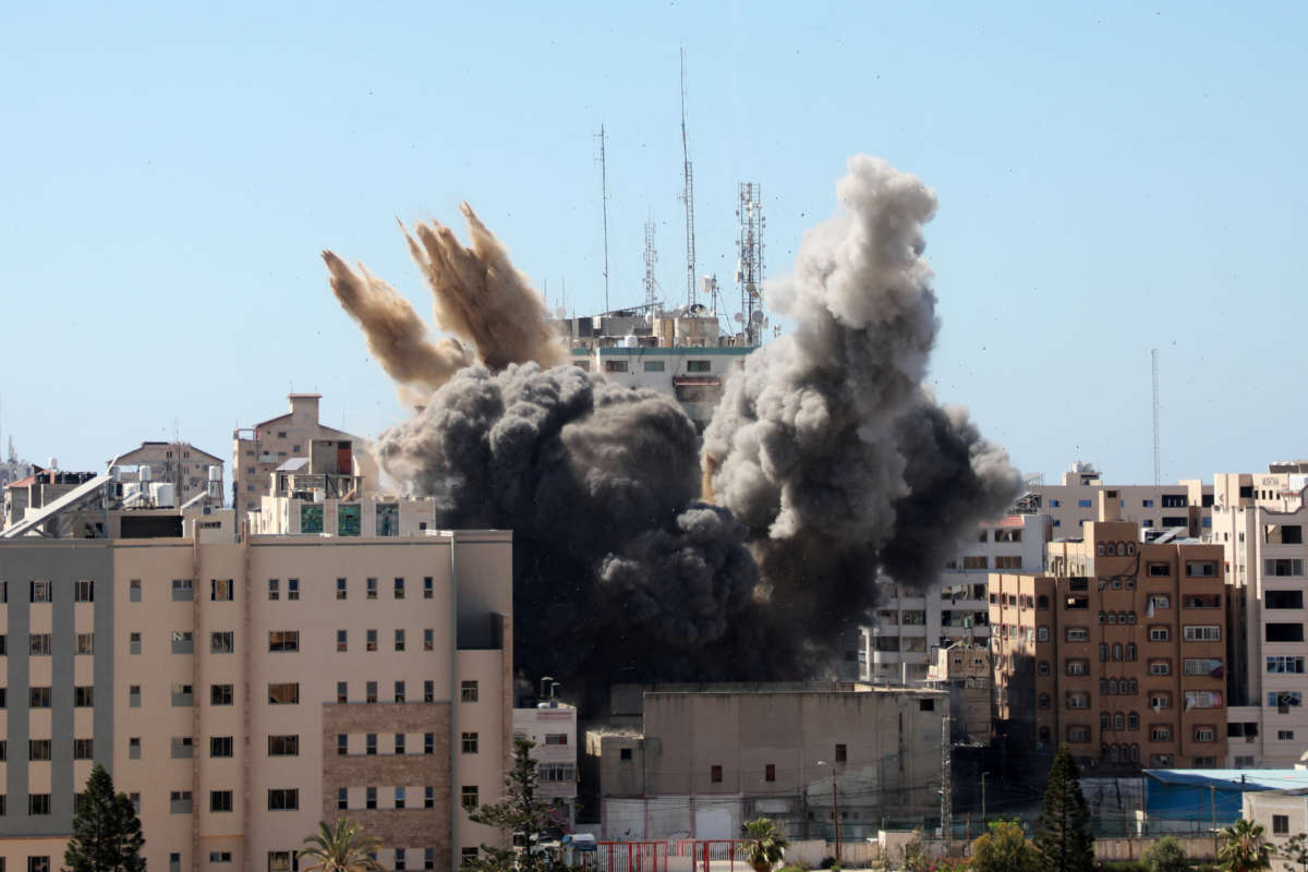 A thick column of smoke rises from the Al-Jalaa building as it is destroyed in an Israeli airstrike in Gaza City, on May 15, 2021.