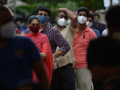 People wait to get themselves inoculated at a vaccination camp in a residential area in Chennai, India, on May 24, 2021.