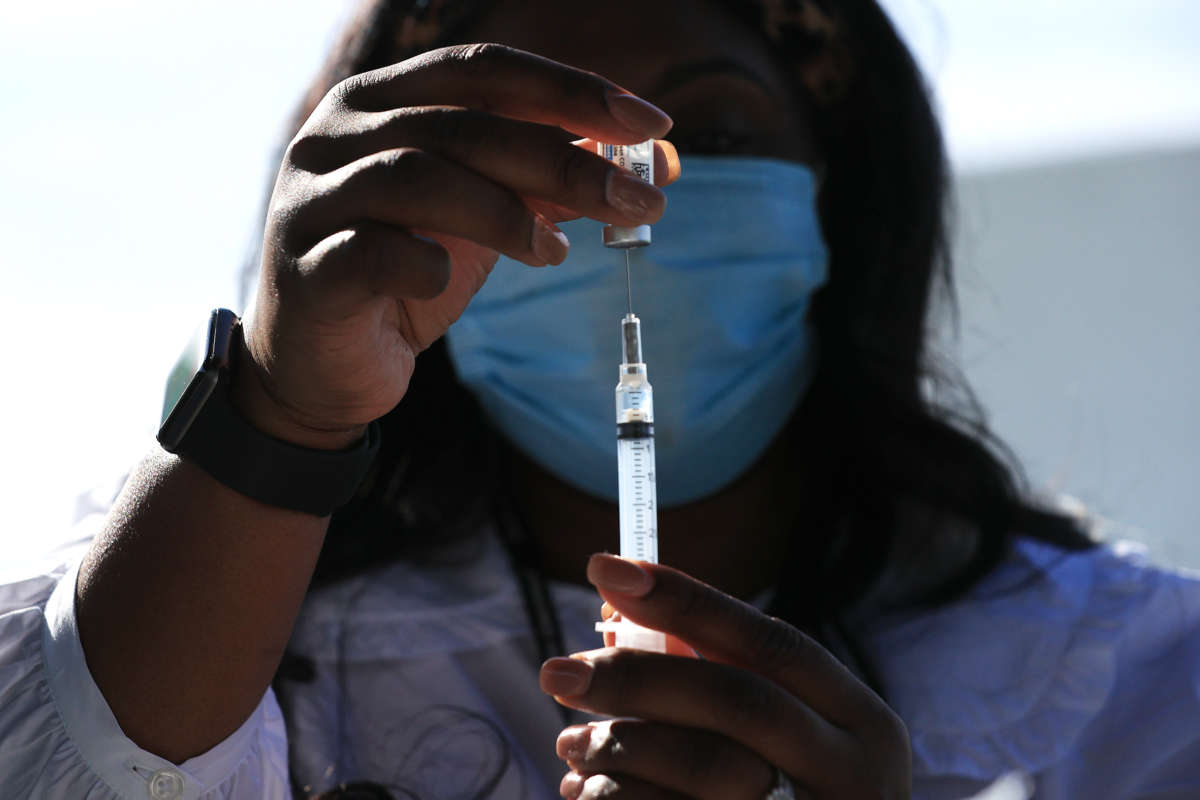 D.C. Health Nurse Manager Ashley Hennigan fills a syringe with a dose of the Johnson & Johnson coronavirus vaccine during a walk-up clinic at the John F. Kennedy Center for the Performing Arts' outdoor Reach area on May 6, 2021 in Washington, D.C.