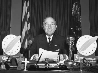 President Harry S. Truman speaks during a television address from the Oval Office.