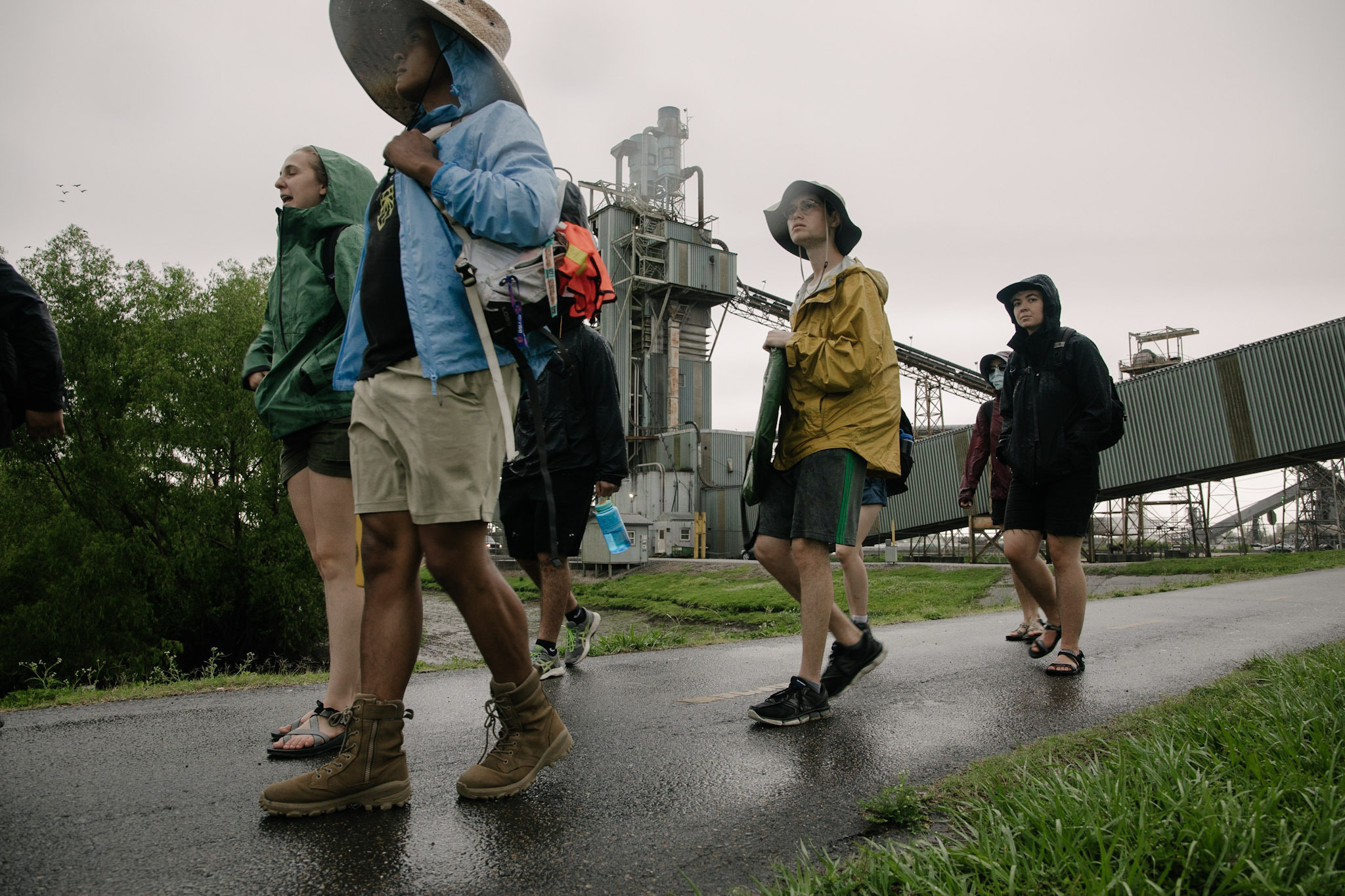 Sunrise movement activists pass by aging fossil fuel infrastructure as they walk from New Orleans to Houston, Texas.