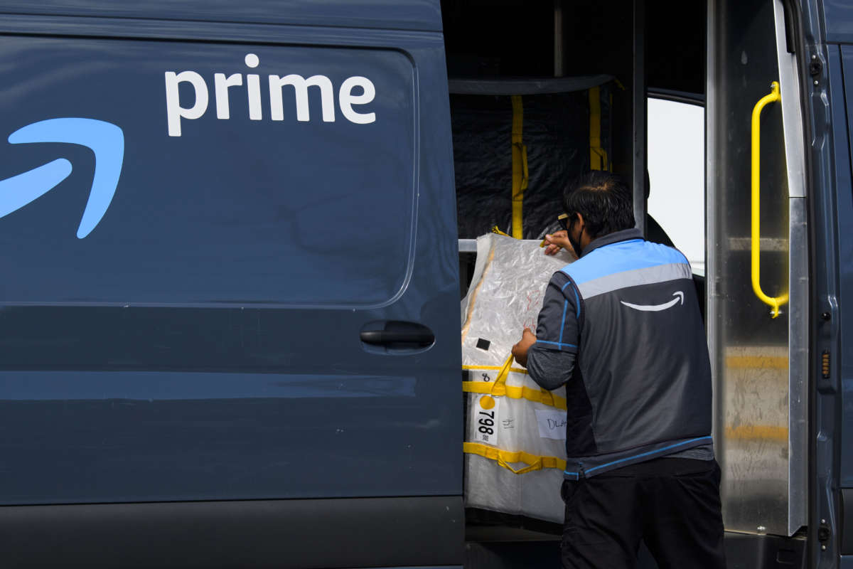 An Amazon.com Inc. delivery driver loads a van outside of a distribution facility on February 2, 2021 in Hawthorne, California.
