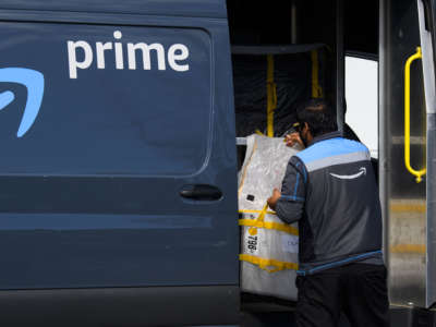 An Amazon.com Inc. delivery driver loads a van outside of a distribution facility on February 2, 2021 in Hawthorne, California.