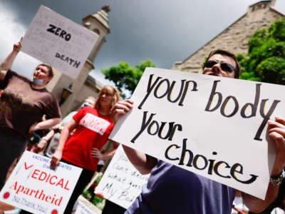 Anti-vaxxers and anti-maskers gather at Indiana University's Sample Gates to protest against mandatory COVID vaccinations that the university is requiring for students, staff and faculty during the upcoming fall semester on June 10, 2021.