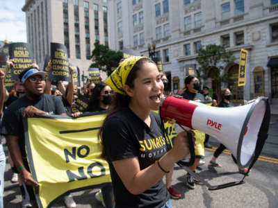 Protesters with the Sunrise Movement march against slow action on infrastructure legislation, job creation and addressing climate change in Washington, D.C., on June 4, 2021.