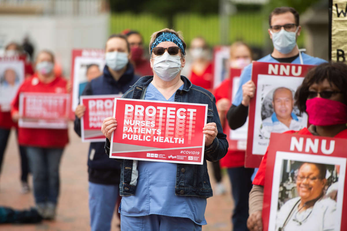 Registered Nurses conduct a demonstration held by National Nurses United (NNU) in Lafayette Park to read aloud names of health care providers who have contracted COVID-19 and died on April 21, 2020.