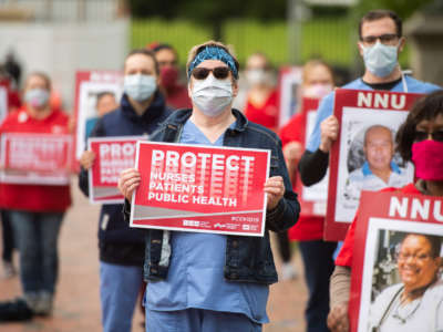 Registered Nurses conduct a demonstration held by National Nurses United (NNU) in Lafayette Park to read aloud names of health care providers who have contracted COVID-19 and died on April 21, 2020.