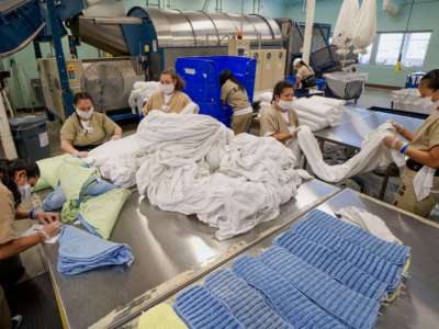 Prisoners work in the laundry room at Las Colinas Women's Detention Facility in Santee, California, on April 22, 2020.