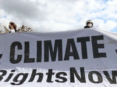 A group of environmentalists gather to stage a demonstration to draw attention to global warming and climate change in Brussels, Belgium, on March 14, 2021.