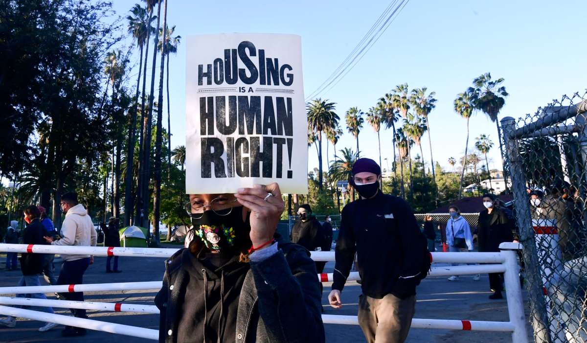Social activists, including a coalition of homeless-serving organizations, homeless residents and supporters rally at the start of a 24-hour vigil to block a planned shutdown of a homeless encampment at Echo Park Lake in Los Angeles, California, on March 24, 2021.