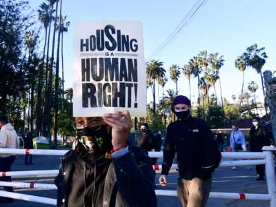 Social activists, including a coalition of homeless-serving organizations, homeless residents and supporters rally at the start of a 24-hour vigil to block a planned shutdown of a homeless encampment at Echo Park Lake in Los Angeles, California, on March 24, 2021.