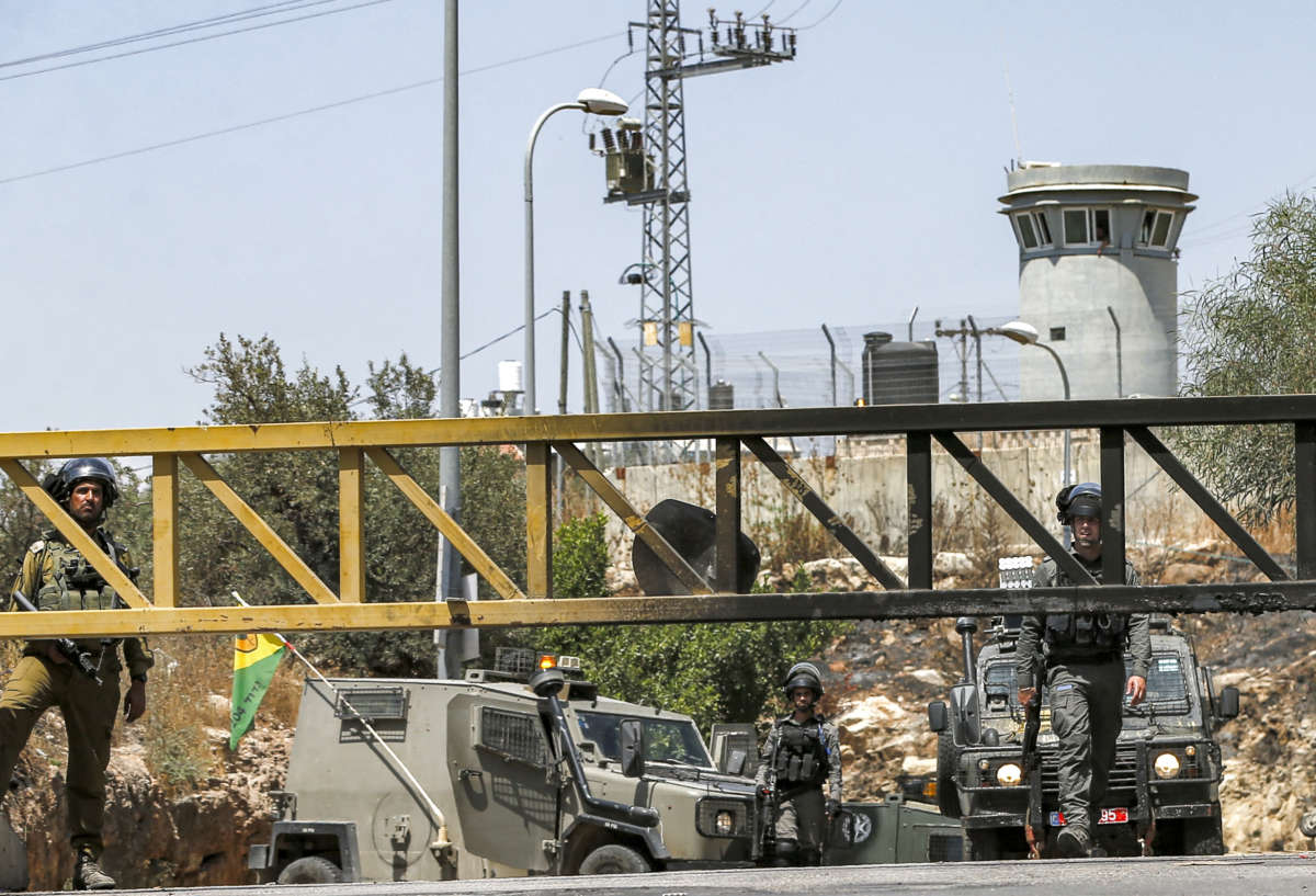 Israeli soldiers and border guards occupy a closed checkpoint entrance leading to the Palestinian village of Ni'lin west of Ramallah in the occupied West Bank, on May 29, 2021 amidst a protest against Israeli settlers' seizure of lands in the area.