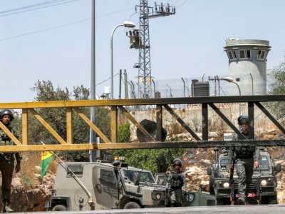 Israeli soldiers and border guards occupy a closed checkpoint entrance leading to the Palestinian village of Ni'lin west of Ramallah in the occupied West Bank, on May 29, 2021 amidst a protest against Israeli settlers' seizure of lands in the area.