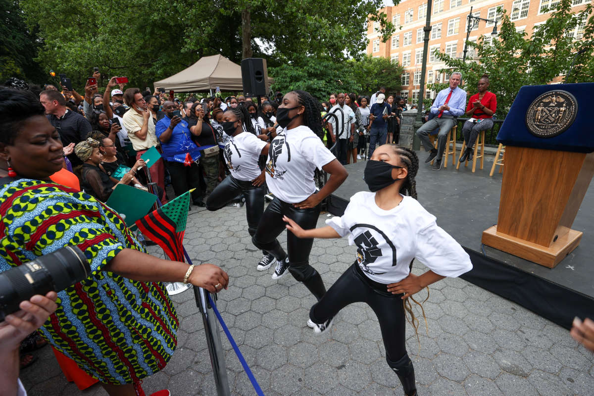 A new federal holiday, Juneteenth, is celebrated in the heart of Harlem in New York City on June 18, 2021. President Joe Biden signed legislation making June 19 a new national holiday.