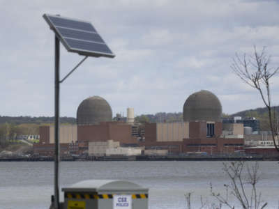 A solar panel is seen in front of the Indian Point Energy Center, a nuclear power plant, from Tomkins Cove, New York, on April 22, 2021.