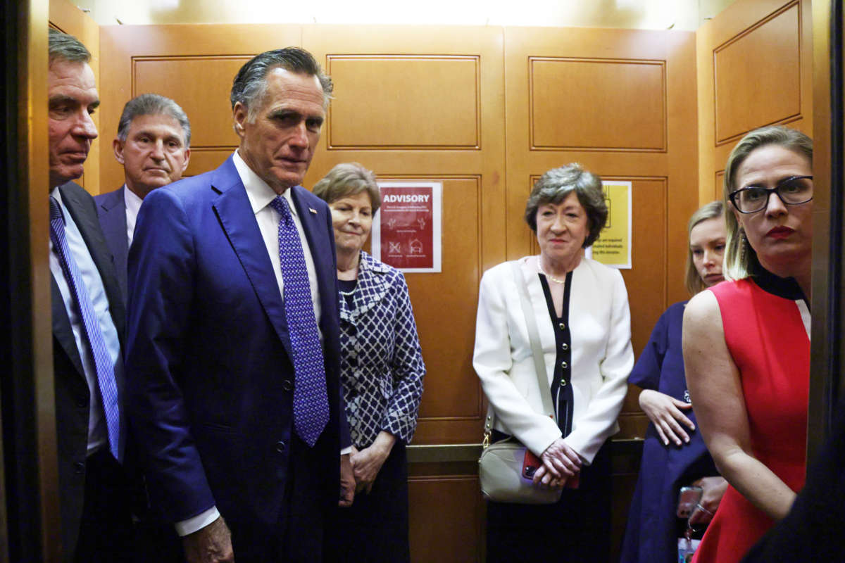 Senators Mark Warner, Joe Manchin, Mitt Romney, Jeanne Shaheen, Susan Collins and Kyrsten Sinema head to the U.S. Capitol on June 8, 2021, in Washington, D.C.