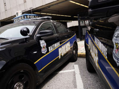 Police cars are seen outside of the Baltimore City Police Headquarters in Baltimore on August 8, 2017.