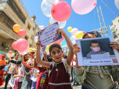 Palestinian children release balloons as a message to the international community calling for the reconstruction of Gaza, end of siege, a safe and dignified life in the Gaza Strip on July 7, 2021.