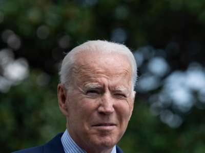 Joseph Robinette Biden squints into the sun, having forgotten his signature aviator sunglasses