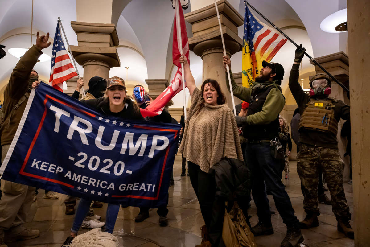 Trump supporters scream at the photographer in the U.S. Capitol
