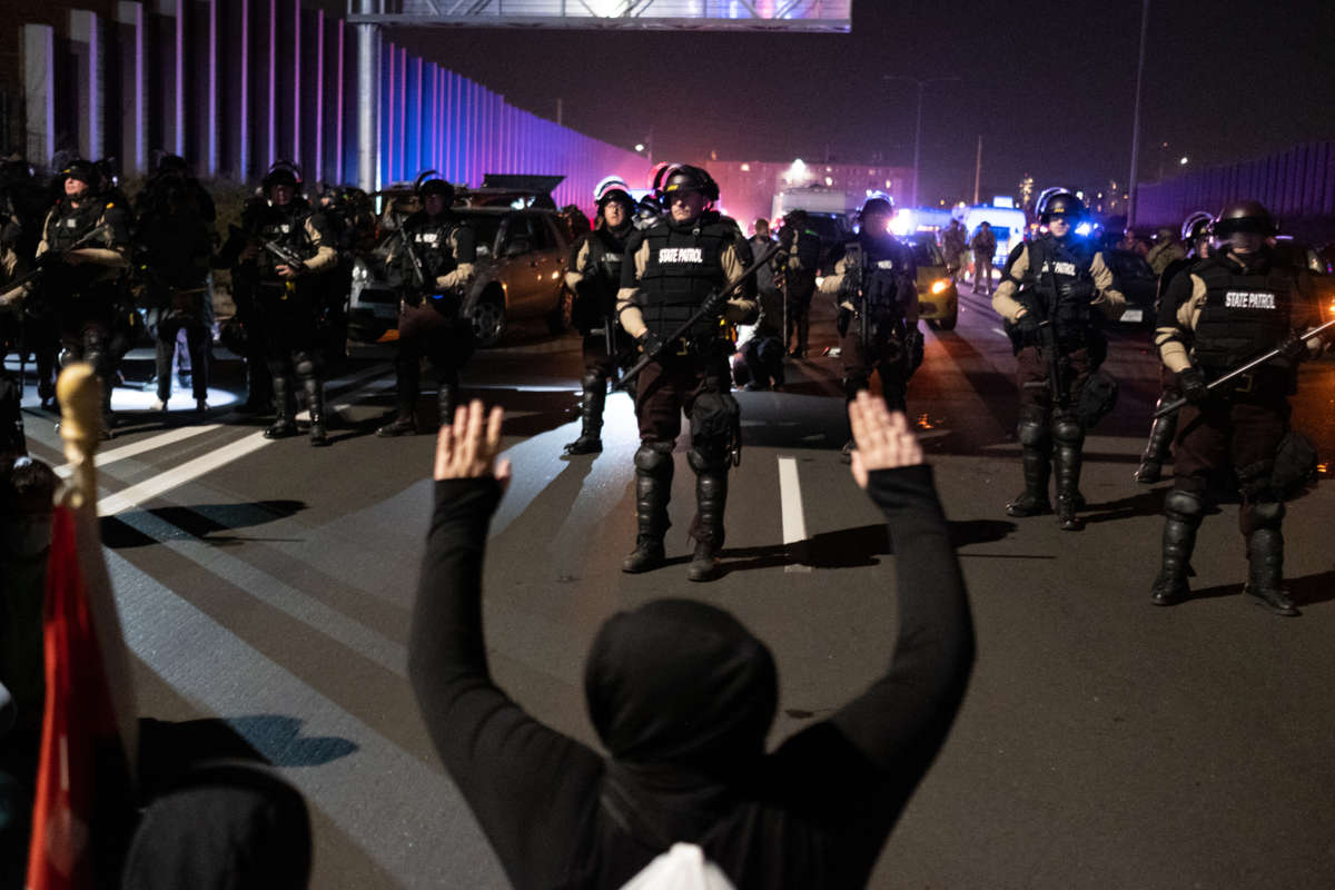 Police in riot gear get in formation to abuse the citizenry